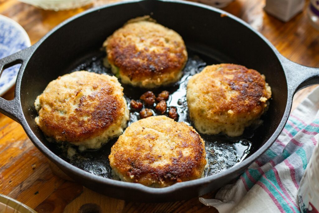A pan filled with food on top of a wooden table
