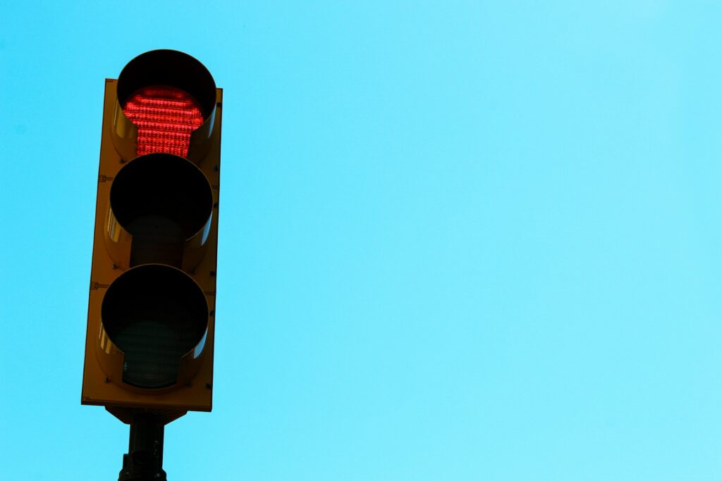 a traffic light with a blue sky in the background
