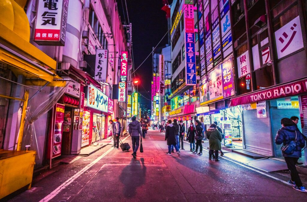 people walking between city building
