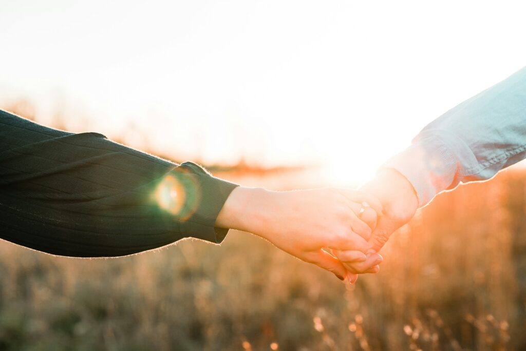 two person holding each other's hands
