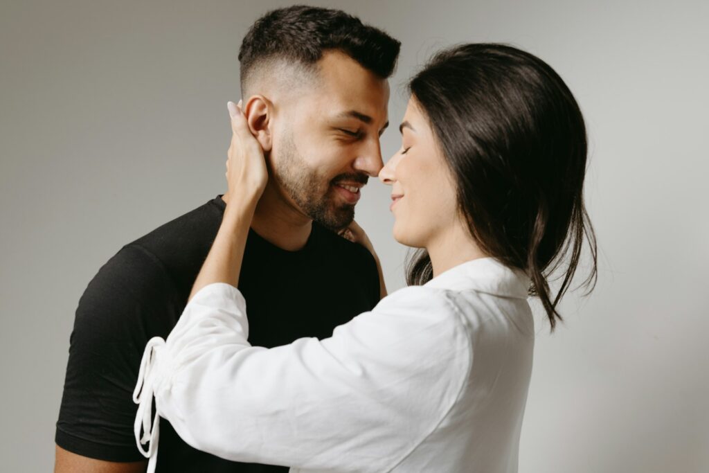 a man and a woman embracing each other
