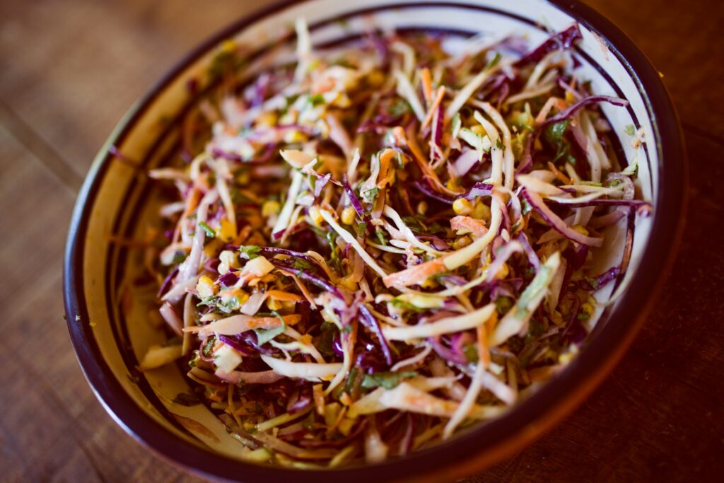 vegetable salad on white and black ceramic bowl
