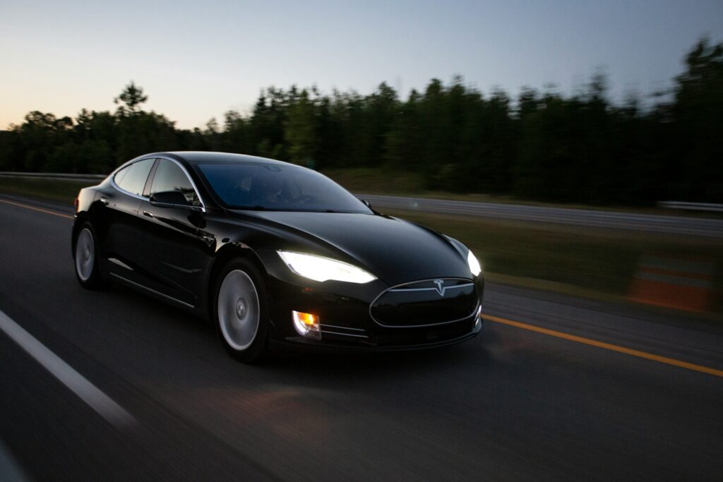 time-lapse photography of black sedan on road
