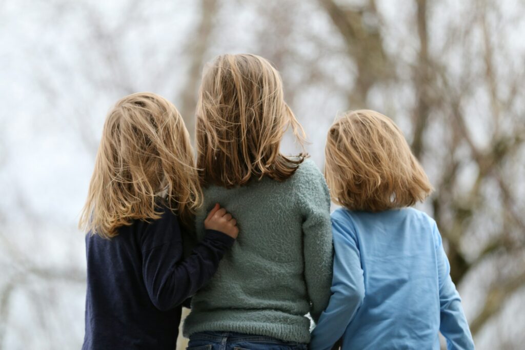2 women in blue and gray sweaters

