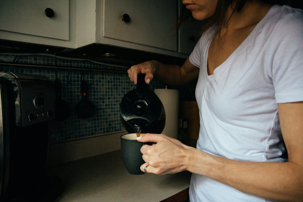 woman in white v neck t-shirt holding black round device
