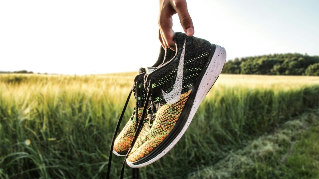 Holding a pair of Nike shoes