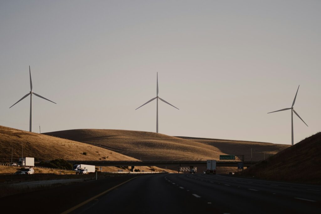a highway with a bunch of windmills in the distance
