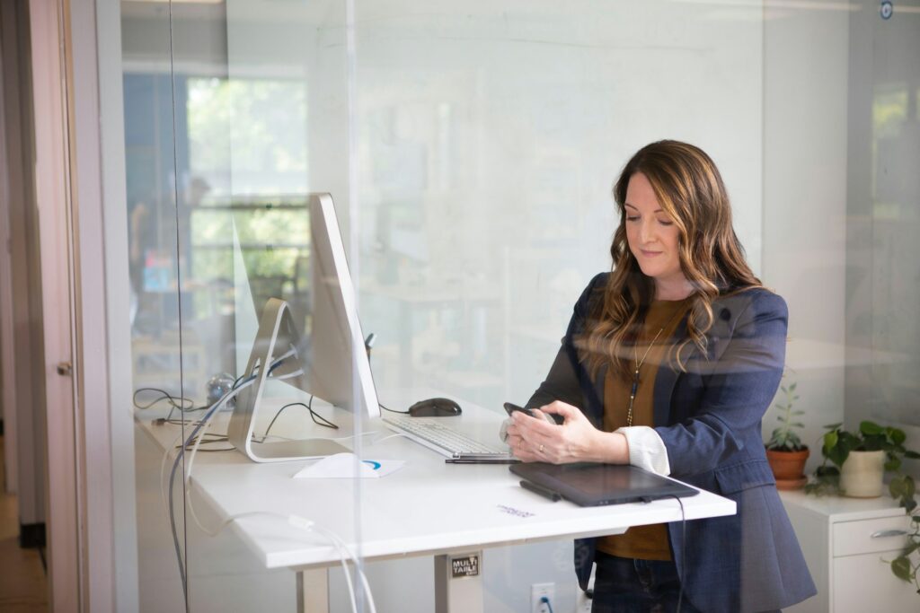 woman in black leather jacket using macbook air
