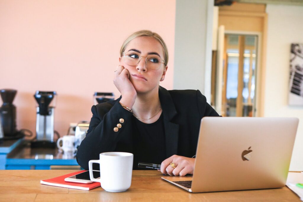 woman in black long sleeve shirt using macbook
