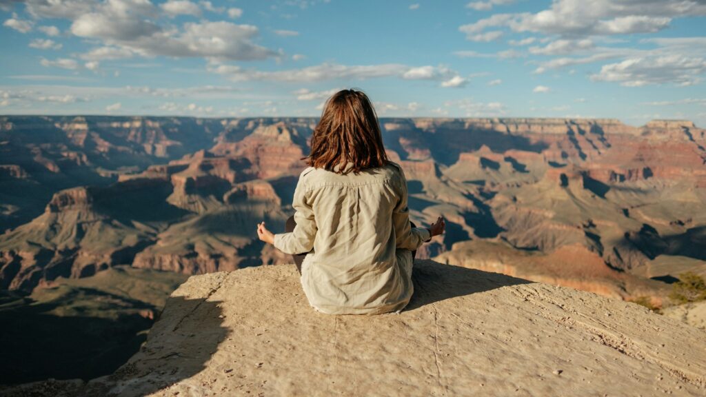 woman sitting on hill
