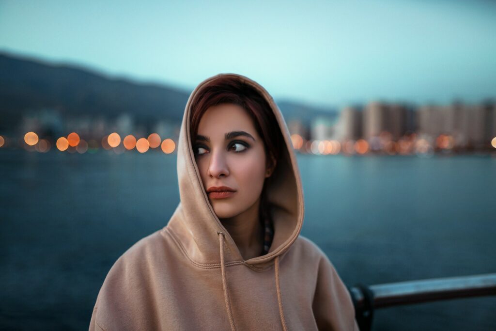 a woman with a scarf on her head looking at the camera