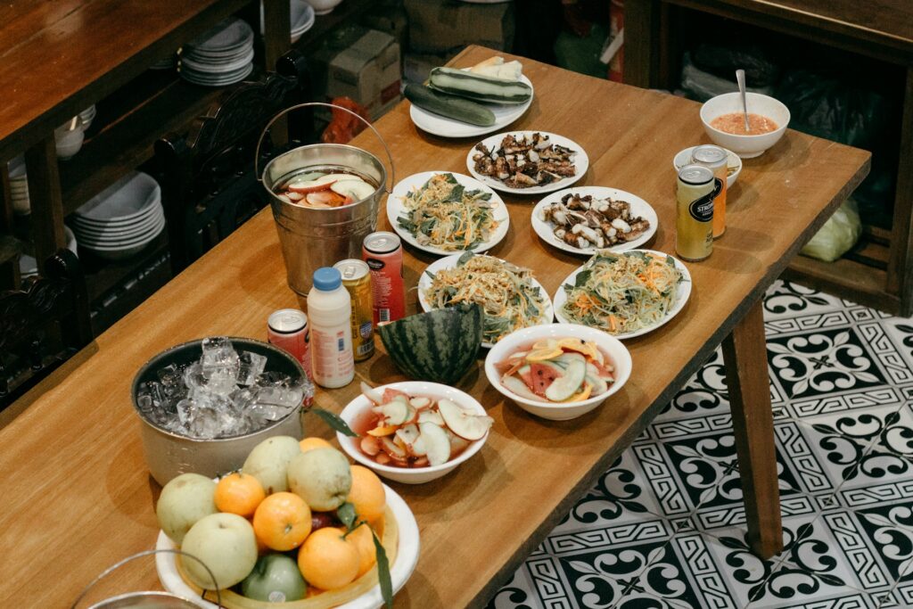 a wooden table topped with bowls of food

