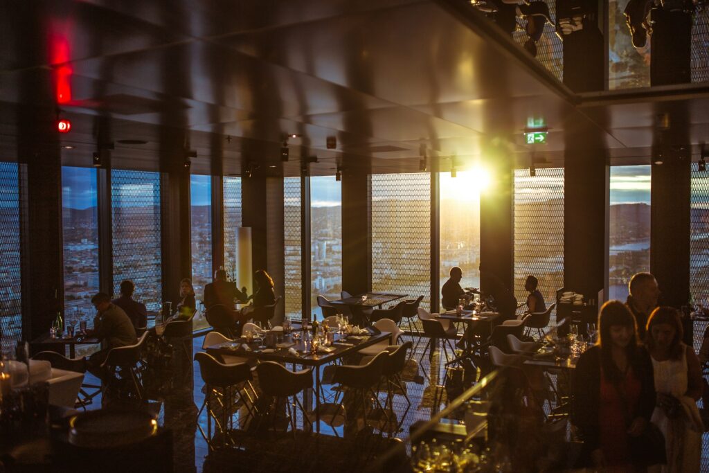 people gathering inside cafe during golden hour
