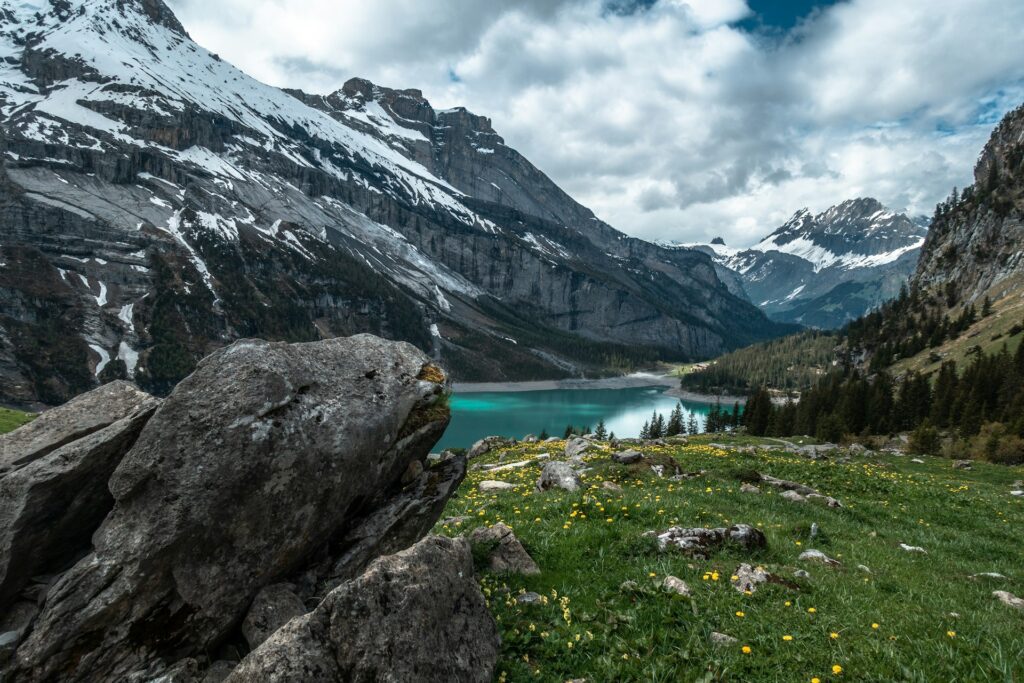 body of water surrounded by mountains during daytime
