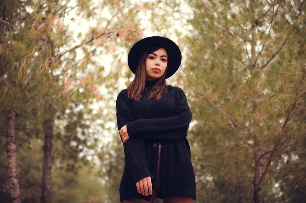Portrait of Woman in Black Hat and Sweater Outdoors
