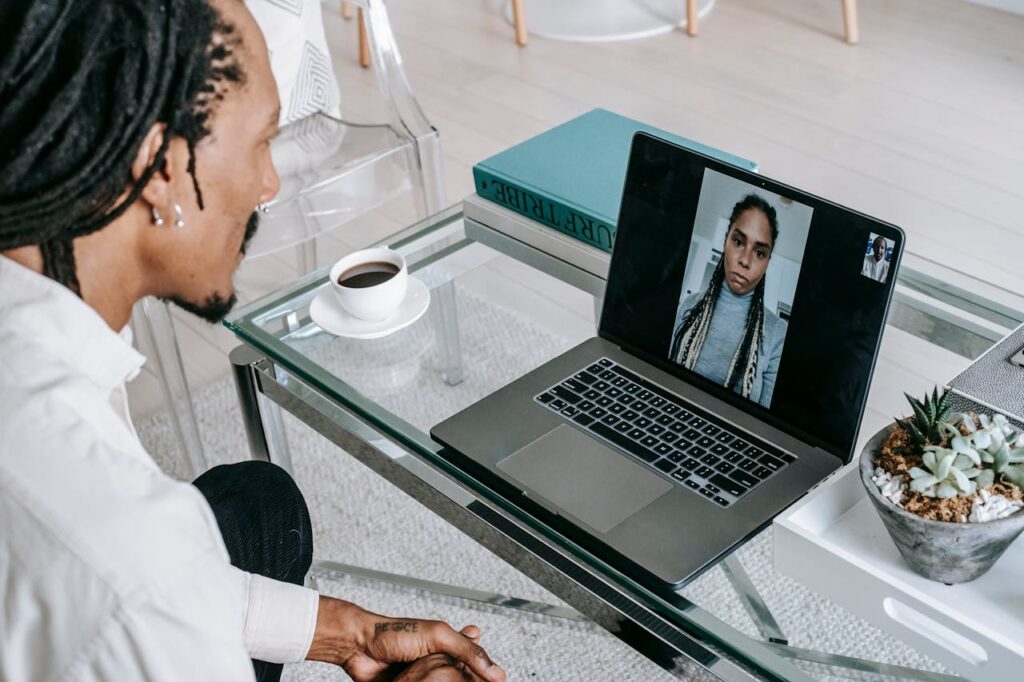 Young black guy having video chat on netbook with girlfriend