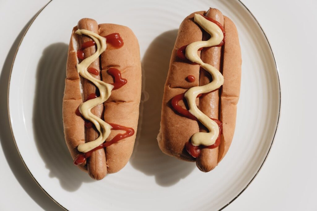 Hot Dogs on White Ceramic Plate
