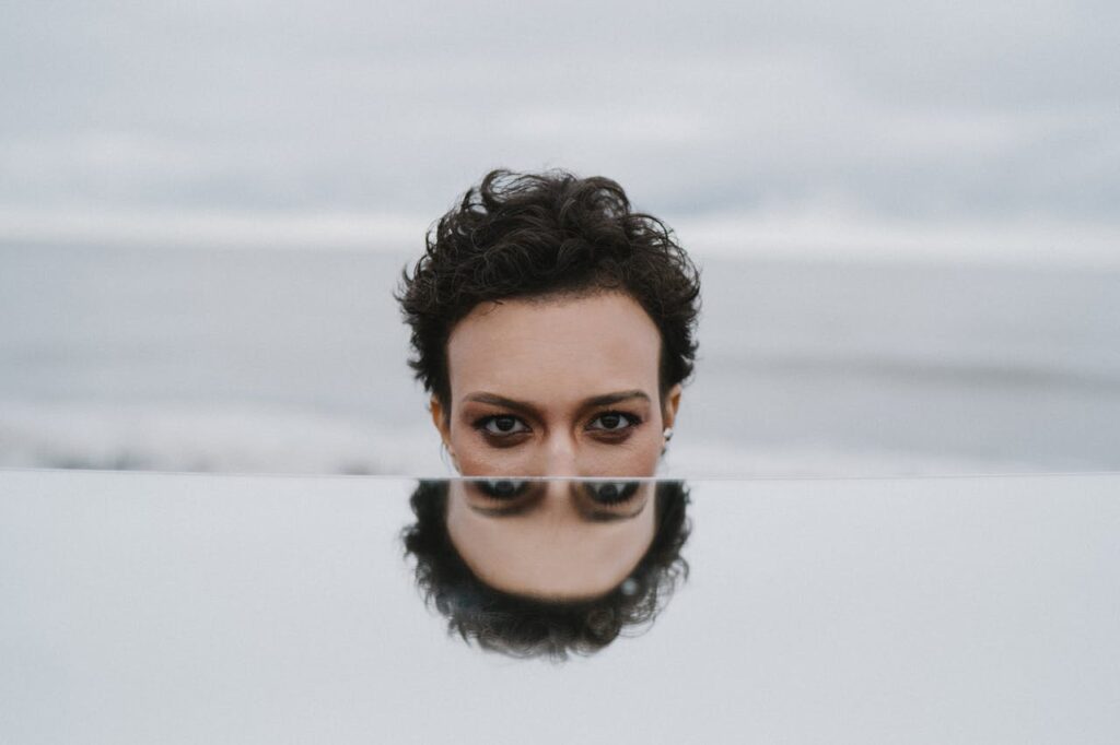 Woman with reflection on mirror