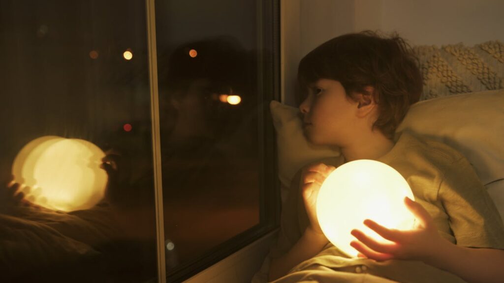 boy holding an led sphere