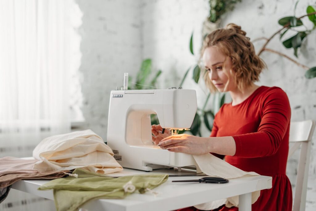 Woman Sewing While Sitting on Chair
