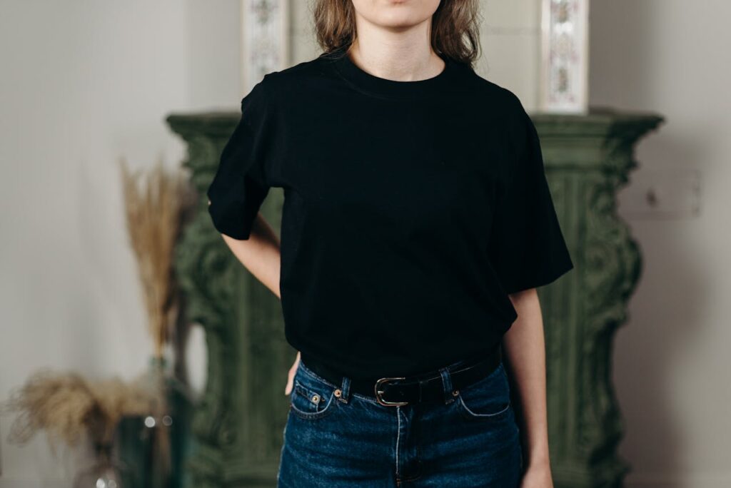 Person Wearing Black T-Shirt and Denim Jeans
