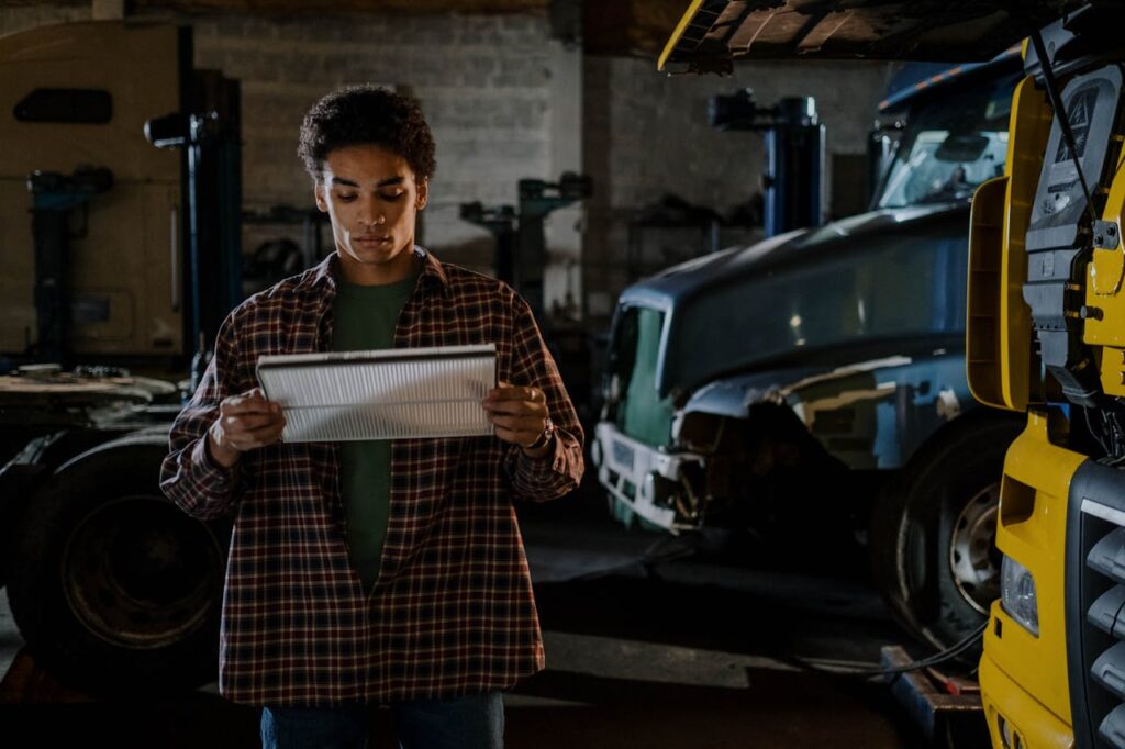 An Auto Mechanic Holding a New Cabin Filter
