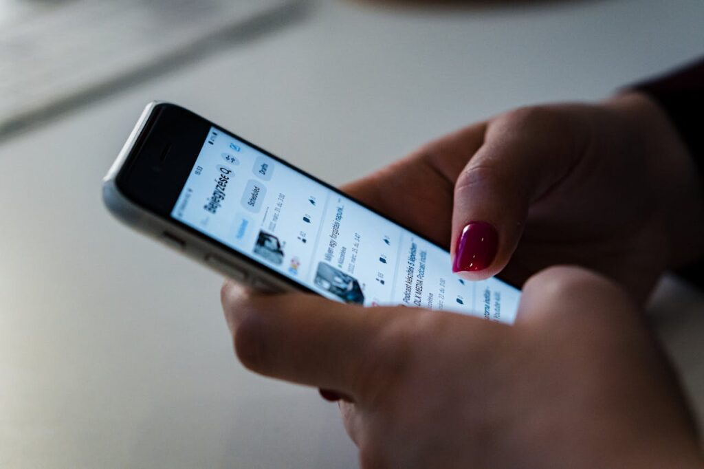 Close Up Photo of a Person Using a Cellphone
