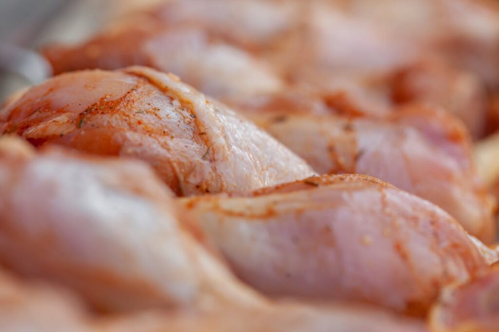 Raw chicken legs with seasonings

