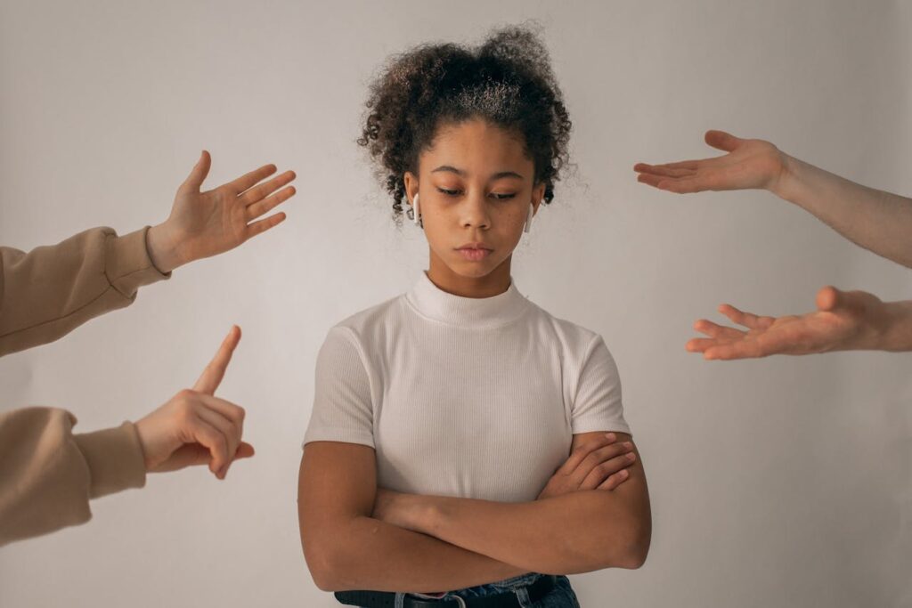 Faceless people scolding discontent black girl
