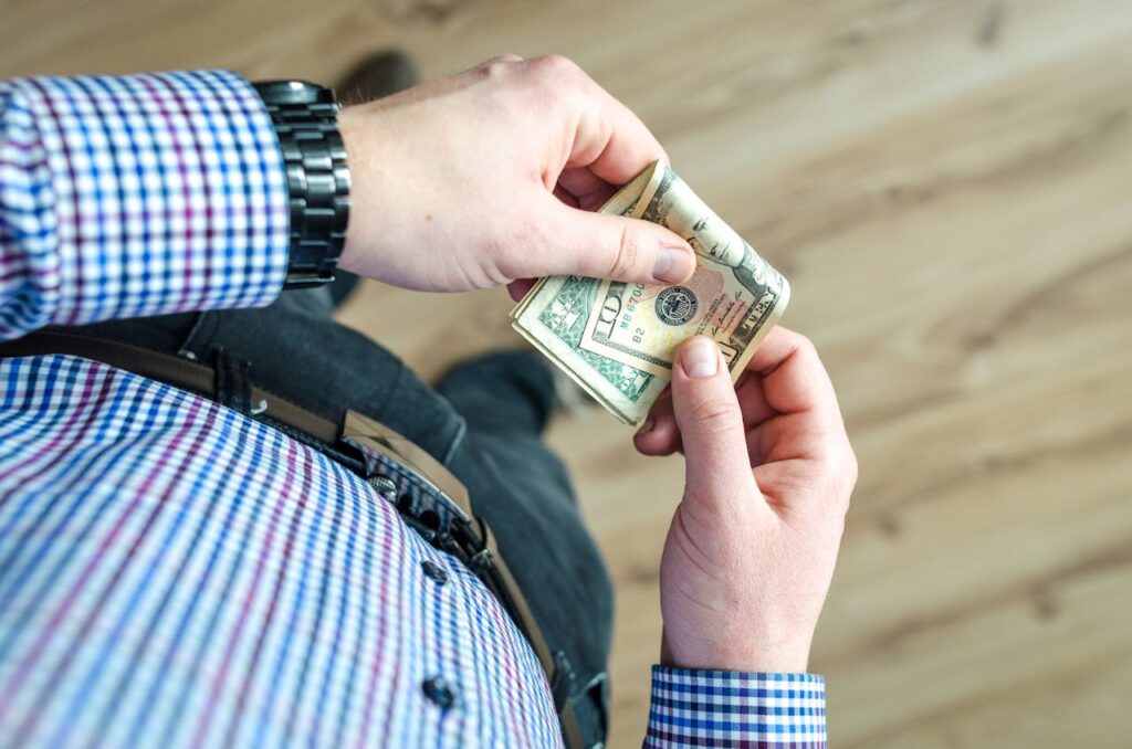 Person Holding 100 Us Dollar Banknote
