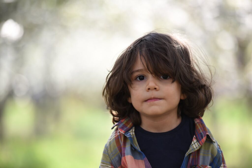 Boy Facing Camera Selective Focus Photography
