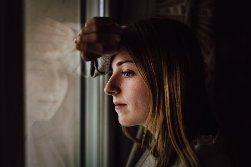 Woman Leaning on Glass Window
