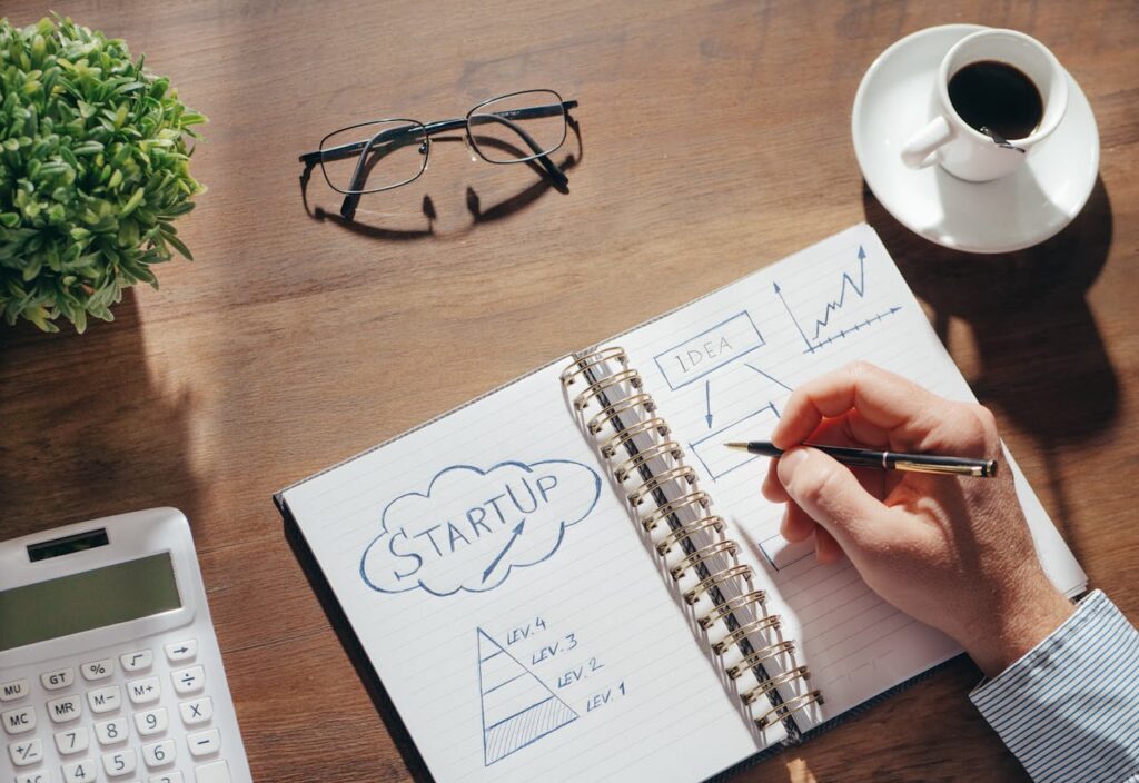 Close-Up Shot of a Person Writing on a Notebook
