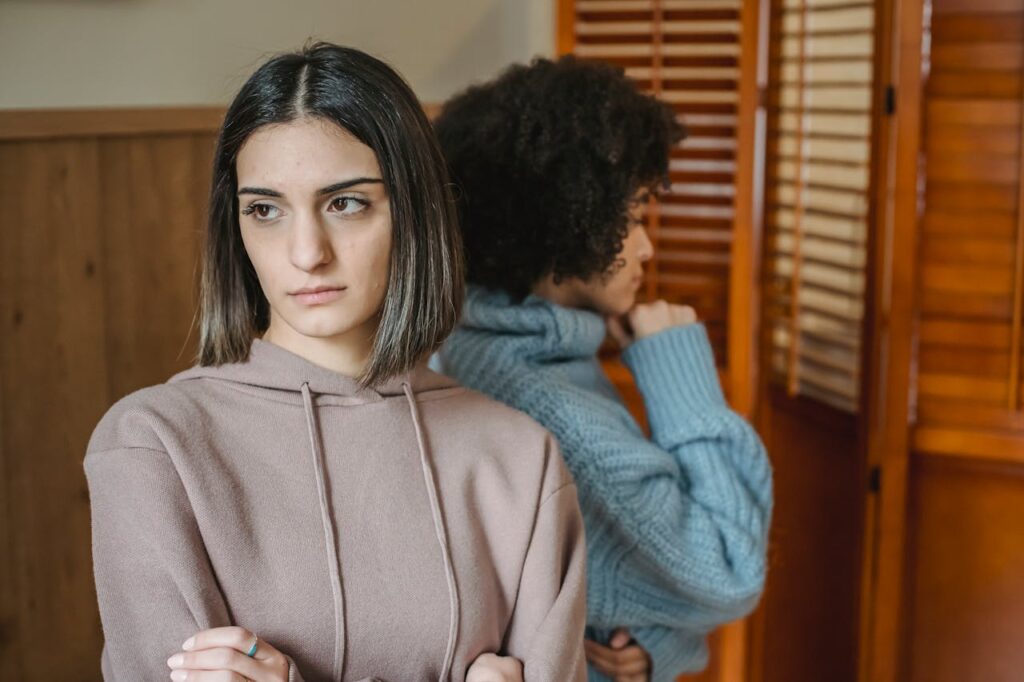 Displeased diverse women in room