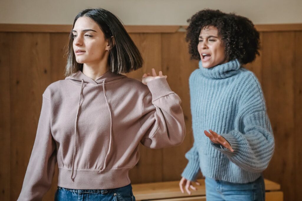 Multiethnic women fighting in room
