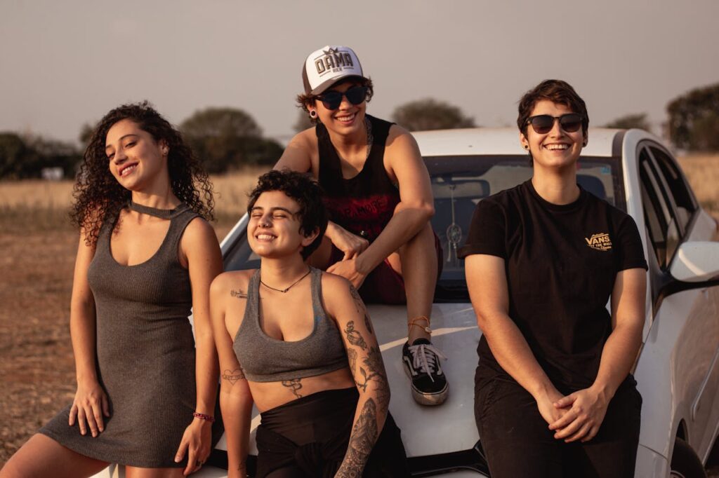 Four People Leaning on White Car