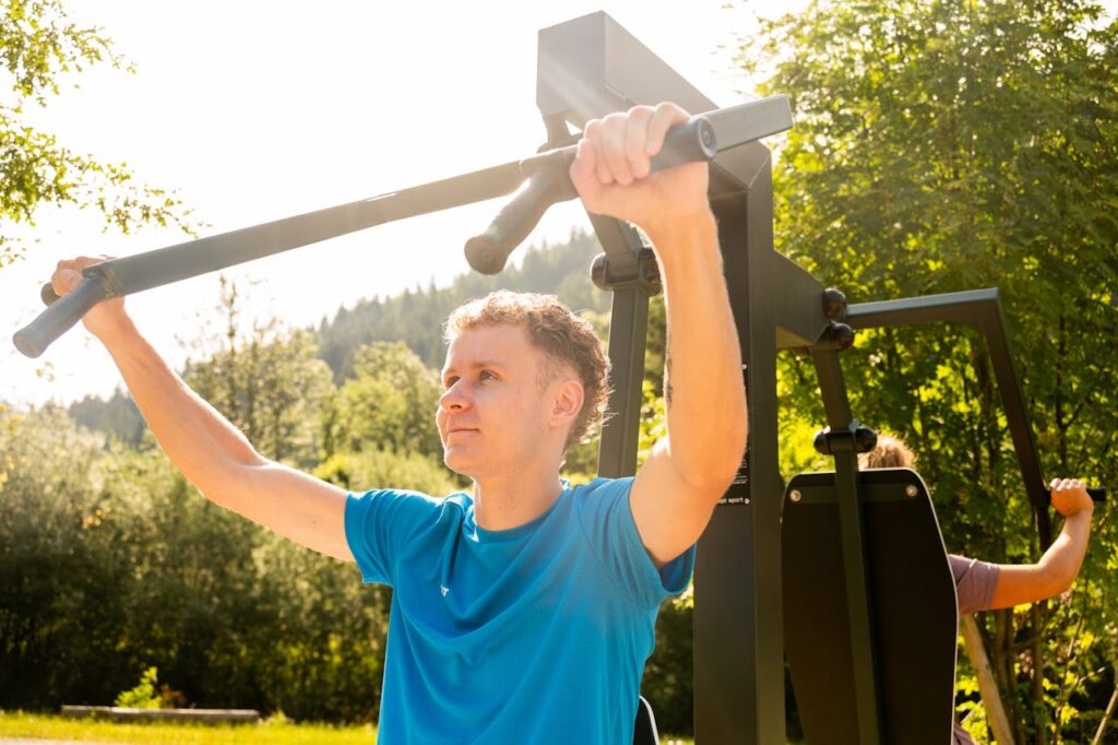 Man Exercising Outdoors on Fitness Equipment