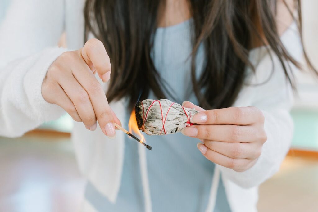 Woman in White Shirt Holding Orange and White Lollipop
