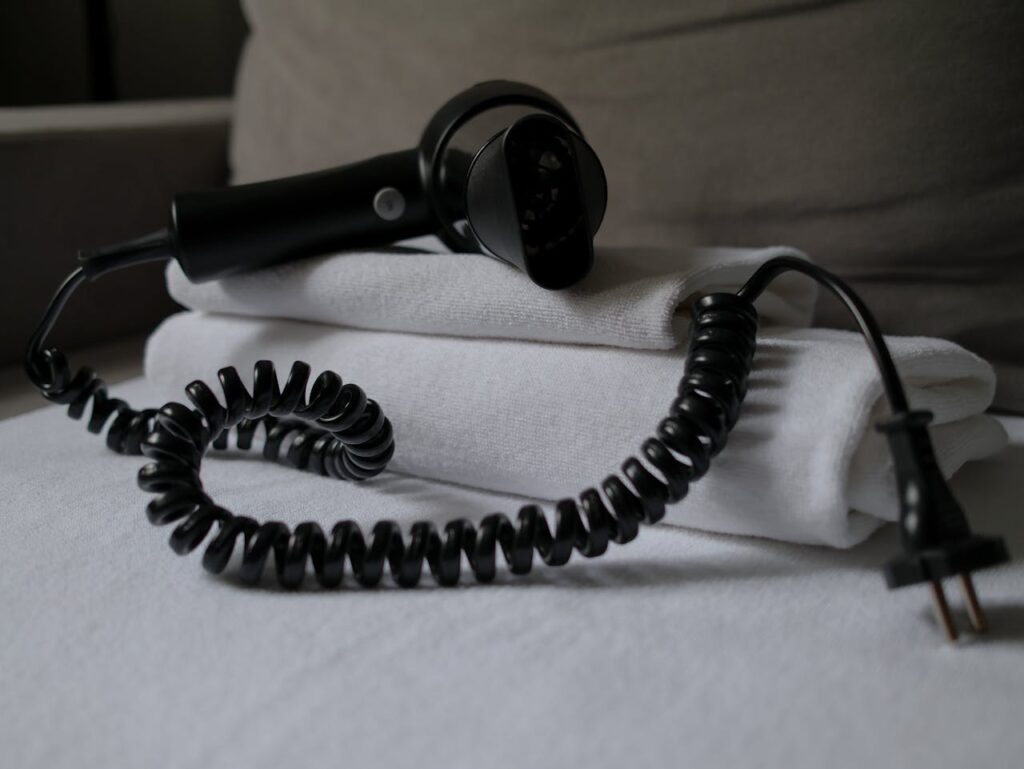 Coiled Hair Dryer on Hotel Towel
