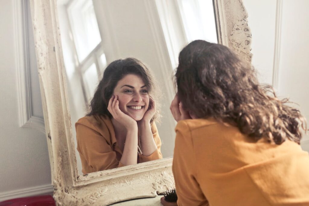 Photo of Woman Looking at the Mirror
