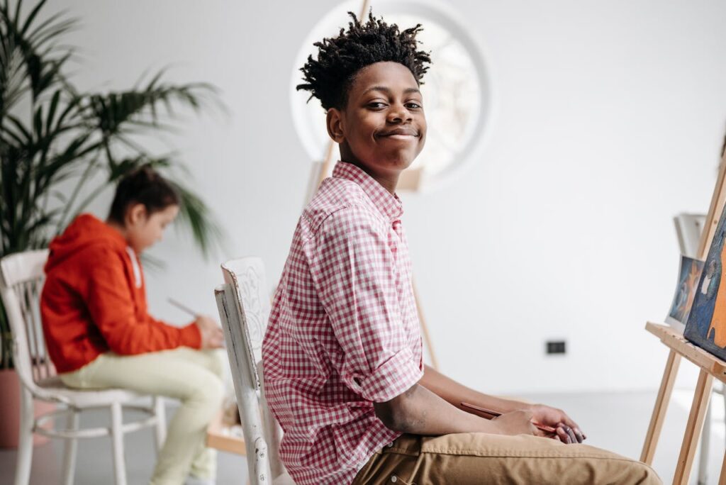 Boy in White and Red Checkered Long Sleeve Shirt Smiling
