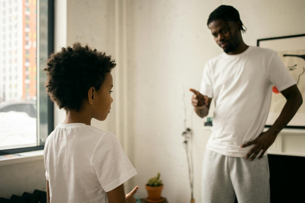 Man and Boy leaning on a White Wall