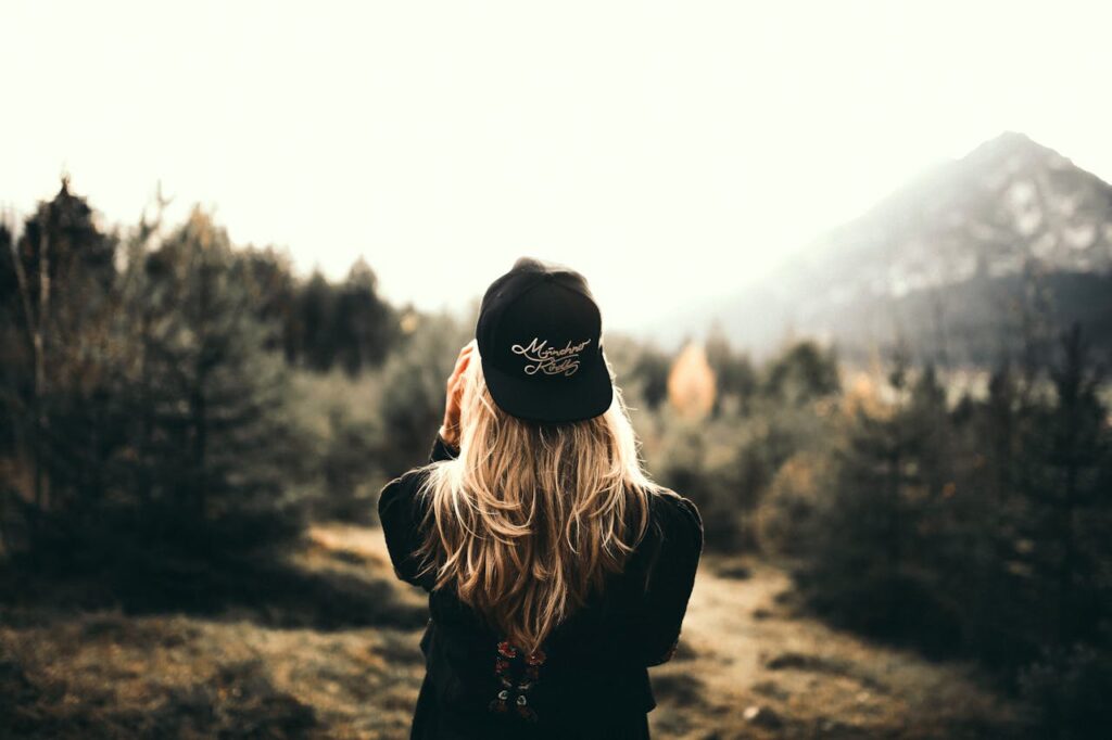 Back View of a Woman Black Sweater and Black Cap
