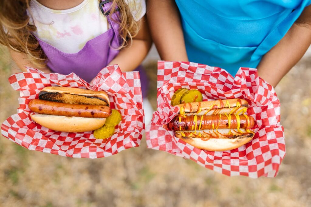 Kids Holding Hotdog Sandwiches
