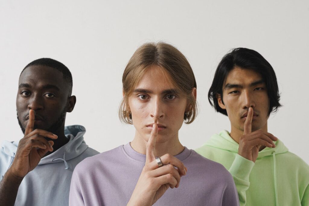 Men Doing a Shushing Hand Gesture
