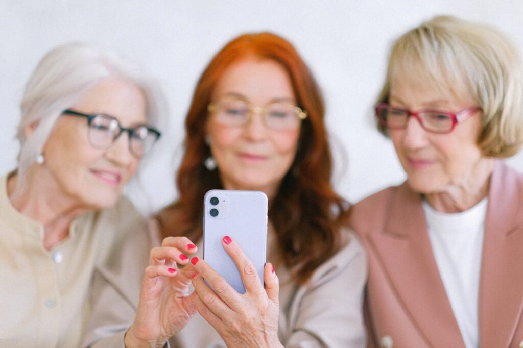 Senior women using smartphone while surfing internet