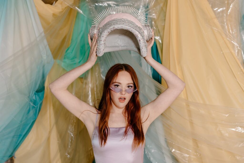 Woman in White Tank Top Holding White and Green Curtain

