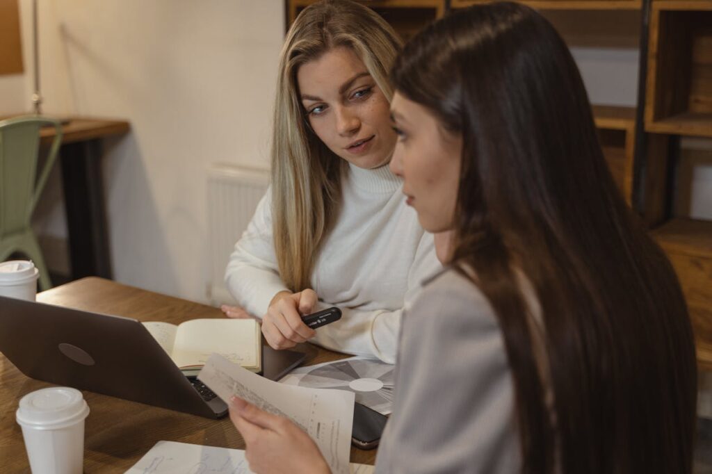 Woman in White Robe Writing on White Paper
