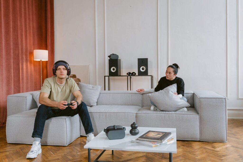 Man playing console with woman talking