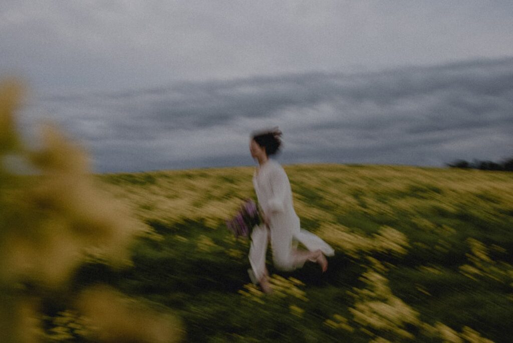 A Person Running on the Flower Field
